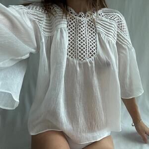 White crochet blouse with lace like cutout pattern